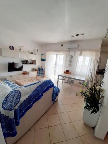 a bedroom with a bed and a living room at Vista bella in Castiglione della Pescaia