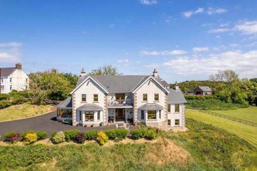 an aerial view of a large white house at Carnbore House BnB in Bushmills