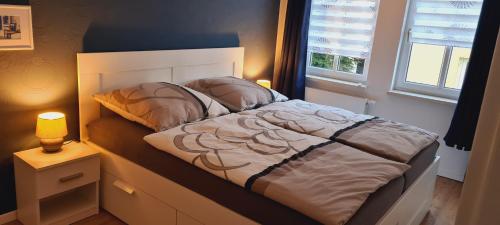a bedroom with a bed and a window and a lamp at Ferienwohnung Helene in Gotha