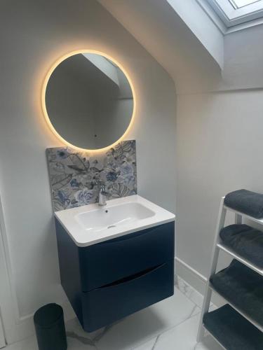 a bathroom with a sink and a mirror at Ballyshannon Stone Town House in Ballyshannon