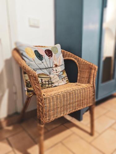 a wicker chair with a pillow on it at La Casa dei Carrai in Pitigliano