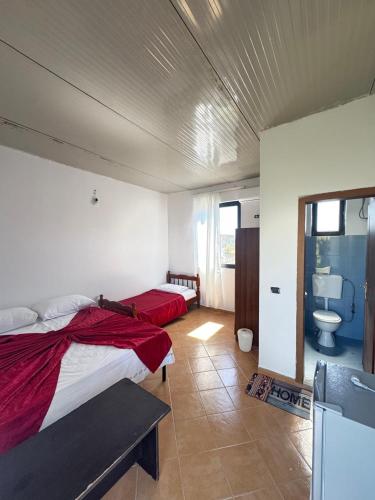 a bedroom with two beds and a sink in it at Morina Rooms in Durrës