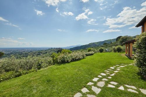 a grassy hillside with a stone walkway at Podere Raffanna Ecologic House in Massa e Cozzile