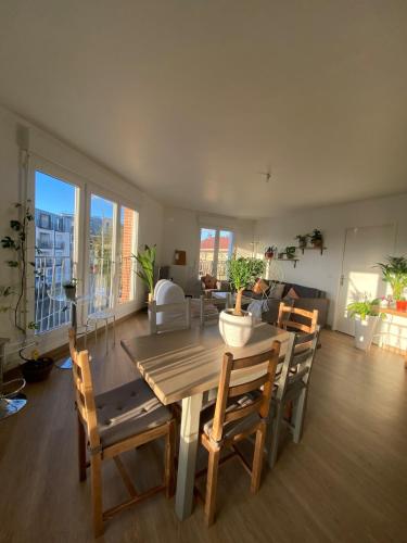 un salon avec une table et des chaises en bois dans l'établissement Cozy room available, à Montreuil