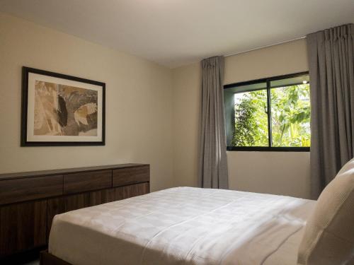 a bedroom with a bed and a window at Plaza colonial suites by Yellowkey in Santo Domingo
