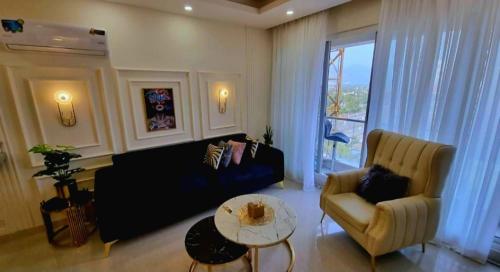 a living room with a couch and a table at Dubai Guest House Karachi in Karachi