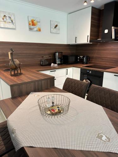 a kitchen with a table with a bowl of food on it at FeWo am Kurpark in Schleiden
