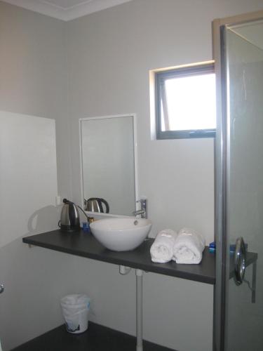 a bathroom with a sink and a mirror at Centrebreak Beach Stay in Green Head