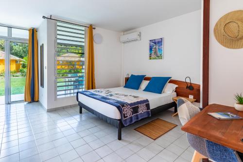 Postel nebo postele na pokoji v ubytování KAWAN NID -Studio Cosy à 200m de la Plage et Jardin privé pour un séjour détente au cœur de Marie Galante