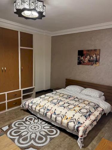 a bedroom with a bed and a chandelier at Resort in Cairo