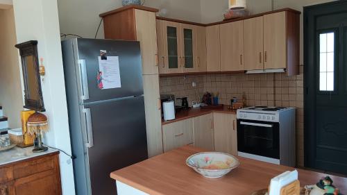 a kitchen with a black refrigerator and a wooden counter at Lichada view in Likhás