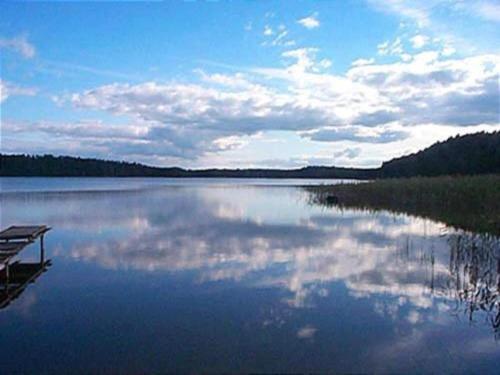 a large body of water with the sky and clouds at Holiday Home in Skrzynia near Lake & Forest in Osiek
