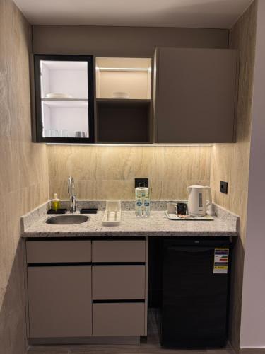 a kitchen with a sink and a counter top at House 98 - Boutique Hotel Stay in Zayed in Sheikh Zayed