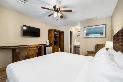 a bedroom with a bed and a flat screen tv at The Claire Hotel in Canyon Lake