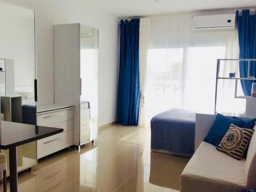 a bedroom with a bed and a table and a couch at Northern Cyprus, Trikomo, Iskele, Long Beach, Caesar Resort, 8 in Mağusa
