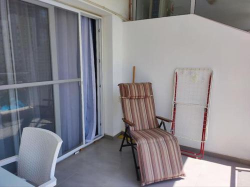 a room with a rocking chair and a window at Northern Cyprus, Trikomo, Iskele, Long Beach, Caesar Resort, 8 in Mağusa