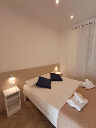 a bedroom with a bed with two towels on it at Residenza Rivellini Tropea in Tropea