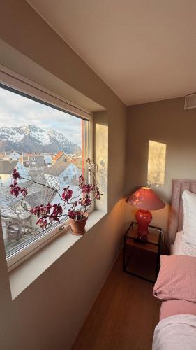 a bedroom with a window with a view of a mountain at Panoramic views in Henningsvær in Henningsvær