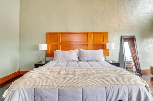 a large bed in a bedroom with two lamps at Stylish Private Balcony Downtown Marshall Studio! in Marshall