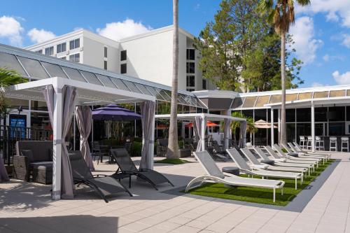 a row of chairs and umbrellas in front of a building at Holiday Inn Resort Kissimmee by the Parks by IHG in Orlando