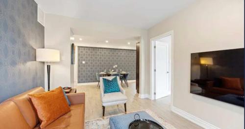 a living room with a couch and a table at Casa Hotel Contemporary 2BR Suite w Patio & BBQ in Toronto