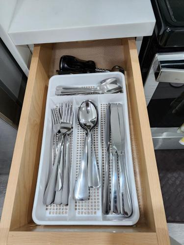 a drawer filled with silver utensils in a cabinet at Gorgeous Two Bedroom Suite in a Quiet, Picturesque Neighborhood! in West Vancouver