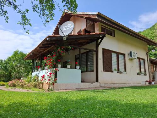 a small house with a sign on the side of it at Vila Petrov in Lukavica