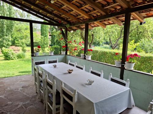 a white table and chairs on a patio at Vila Petrov in Lukavica