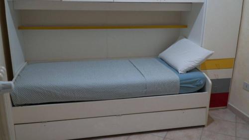 a small bed in a small room at Barbahouse in Monte SantʼAngelo