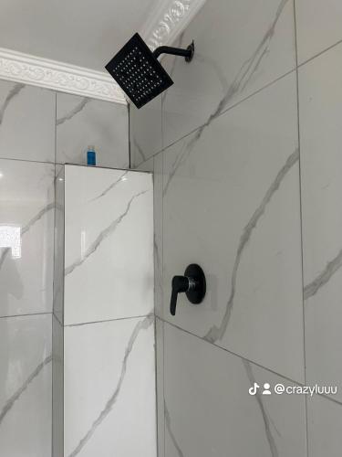 a shower with a glass door in a bathroom at Rose's Lodge in Ga-Selala