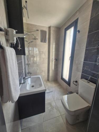 a bathroom with a sink and a toilet at Velder House Urla in Urla