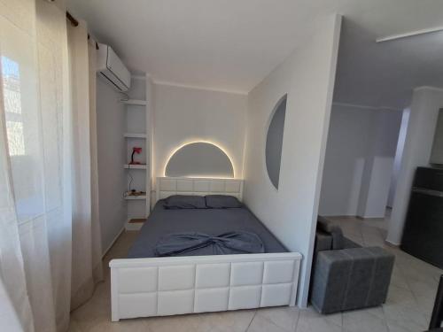 a bedroom with a bed in a white room at Shëngjin Beach Nest in Lezhë