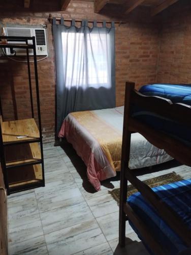 a bedroom with a bunk bed and a window at Finca La Huella in Santiago del Estero