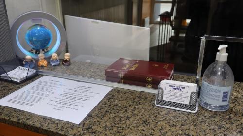 a bottle of soap and a book on a counter at Town Centre Inn - Parry Sound in Parry Sound