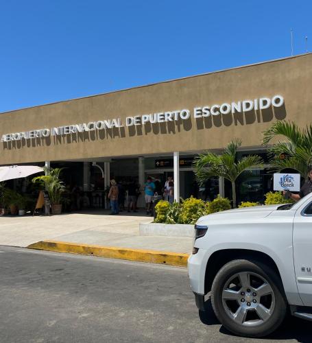 a white truck parked in front of a building at Casa Villa Noa in Puerto Escondido