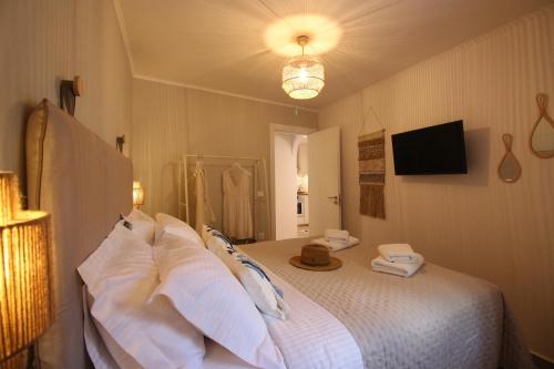 a bedroom with a bed with white pillows at Azure Haven in Hydra