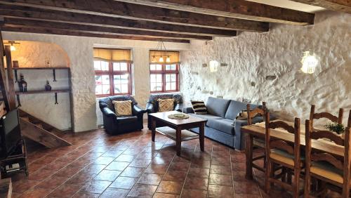a living room with a blue couch and a table at Deluxe Apartments in the city center with Balcony in Pärnu