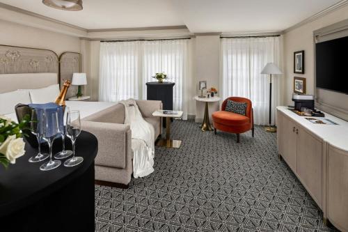 a hotel room with a bed and a couch at The Talbott, Autograph Collection in Chicago