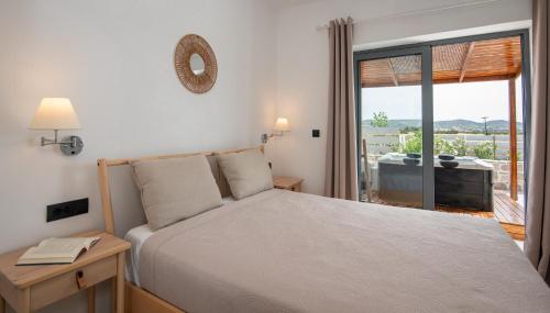 a bedroom with a bed and a window with a view at Livadi Resort in Adamas