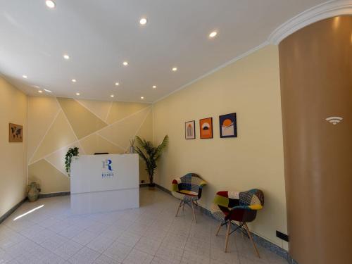 a lobby with two chairs and a table in a building at Residence Rodi in Alassio