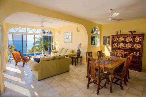 a living room with a couch and a table at Casa de La Paz - Beautiful Beachfront Villa in Puerto Escondido