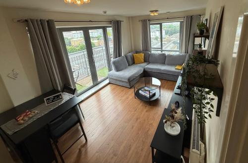 a living room with a couch and a table at Sunset Heights Bright 2BR with City Views and Free Parking in London