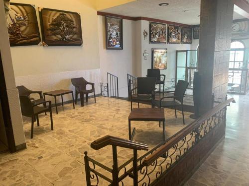 a waiting room with chairs and tables in a building at Hotel Tonalà in Tonalá