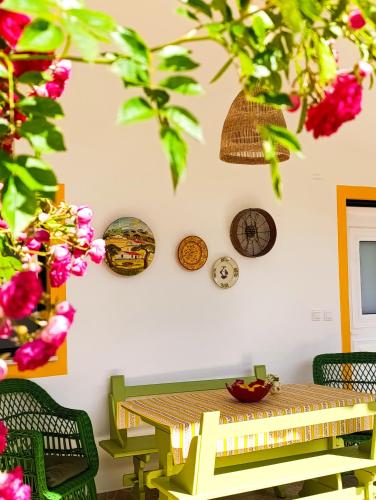 a room with a table and clocks on the wall at Casa do Sol - Turismo Rural - Nazaré Alcobaça in Cos
