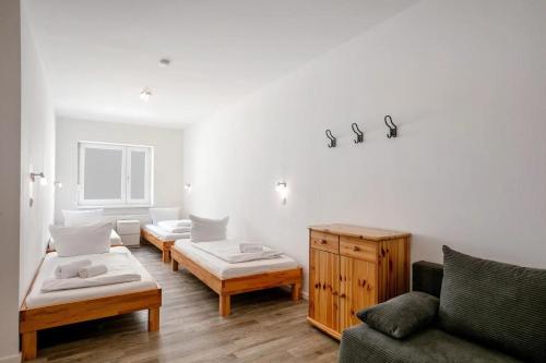 a living room with two beds and a couch at Apartments Tempelhof in Berlin