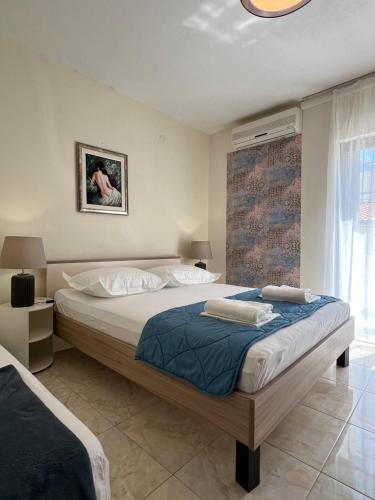 a bedroom with a large bed and a window at Villa Marie in Baška Voda