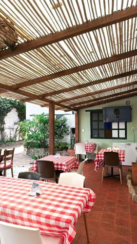 a restaurant with red and white checked tables and chairs at Casa Ande Hotel boutique in Villa de Leyva