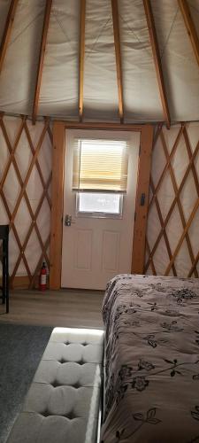 a room with a bed and a window and a door at Crazy Horse - APT 1 in Kanab