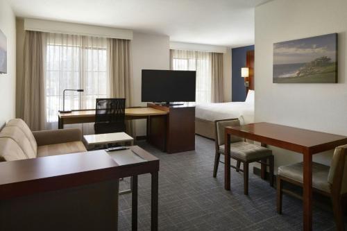 a hotel room with a bed and a living room at Residence Inn San Diego Del Mar in San Diego