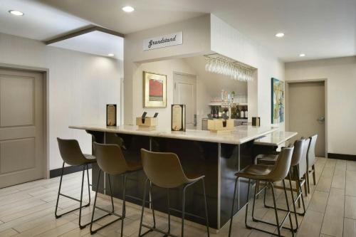 a large kitchen with a bar with stools at Residence Inn San Diego Del Mar in San Diego